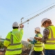 Back view of a group of construction workers analyzing a work site