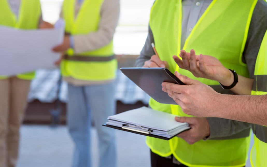 Construction workers looking over permit information