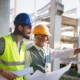 Image of workers on a construction site, looking at blueprints.